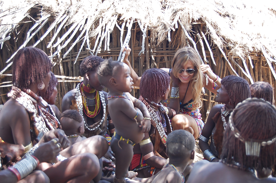 White women vacation in polygamous African tribes #16970380