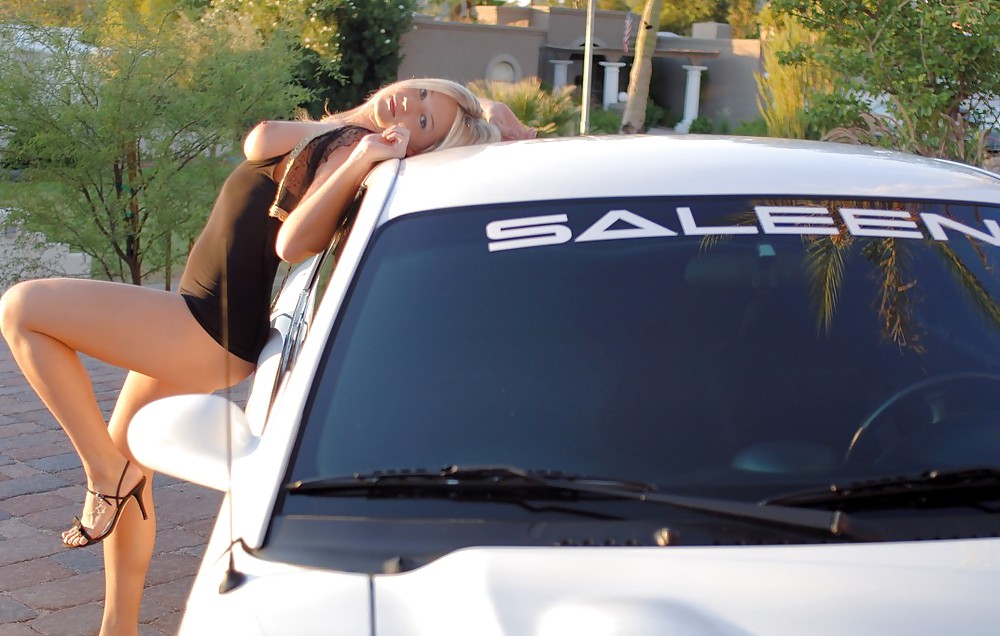 Hot blonde posing with white car #17379310