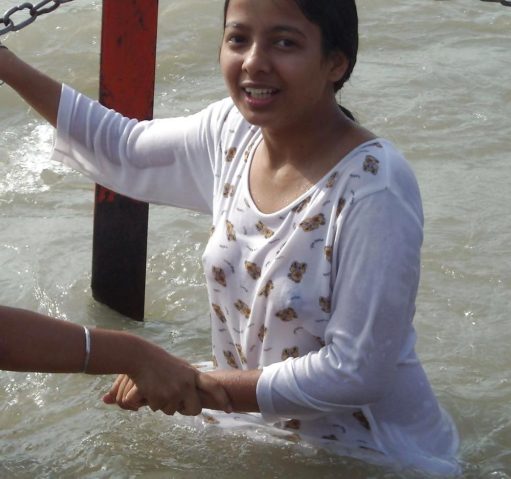 Indian Girls bathing at river ganga  #11575966