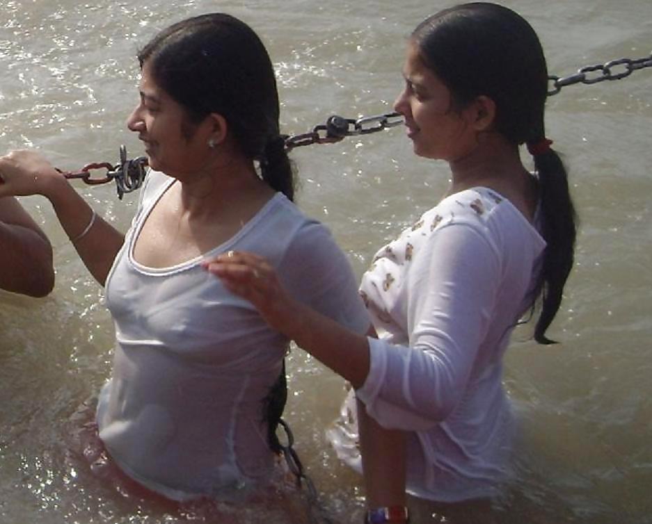 Indian Girls bathing at river ganga  #11575975