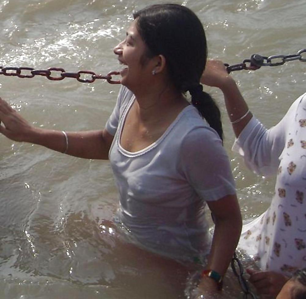 Indian Girls bathing at river ganga  #11575985