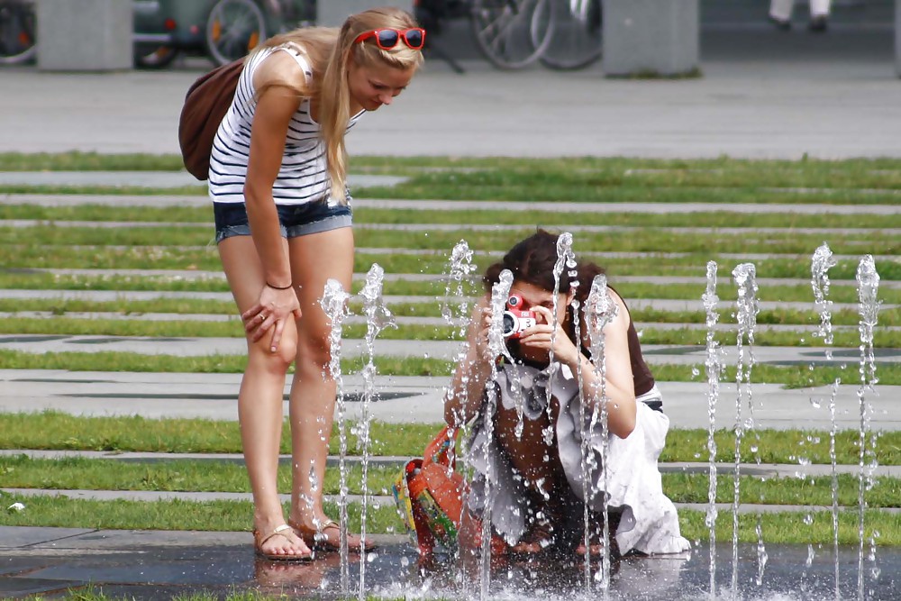 Two sexy and young girls takes photos on a fountain #11126406