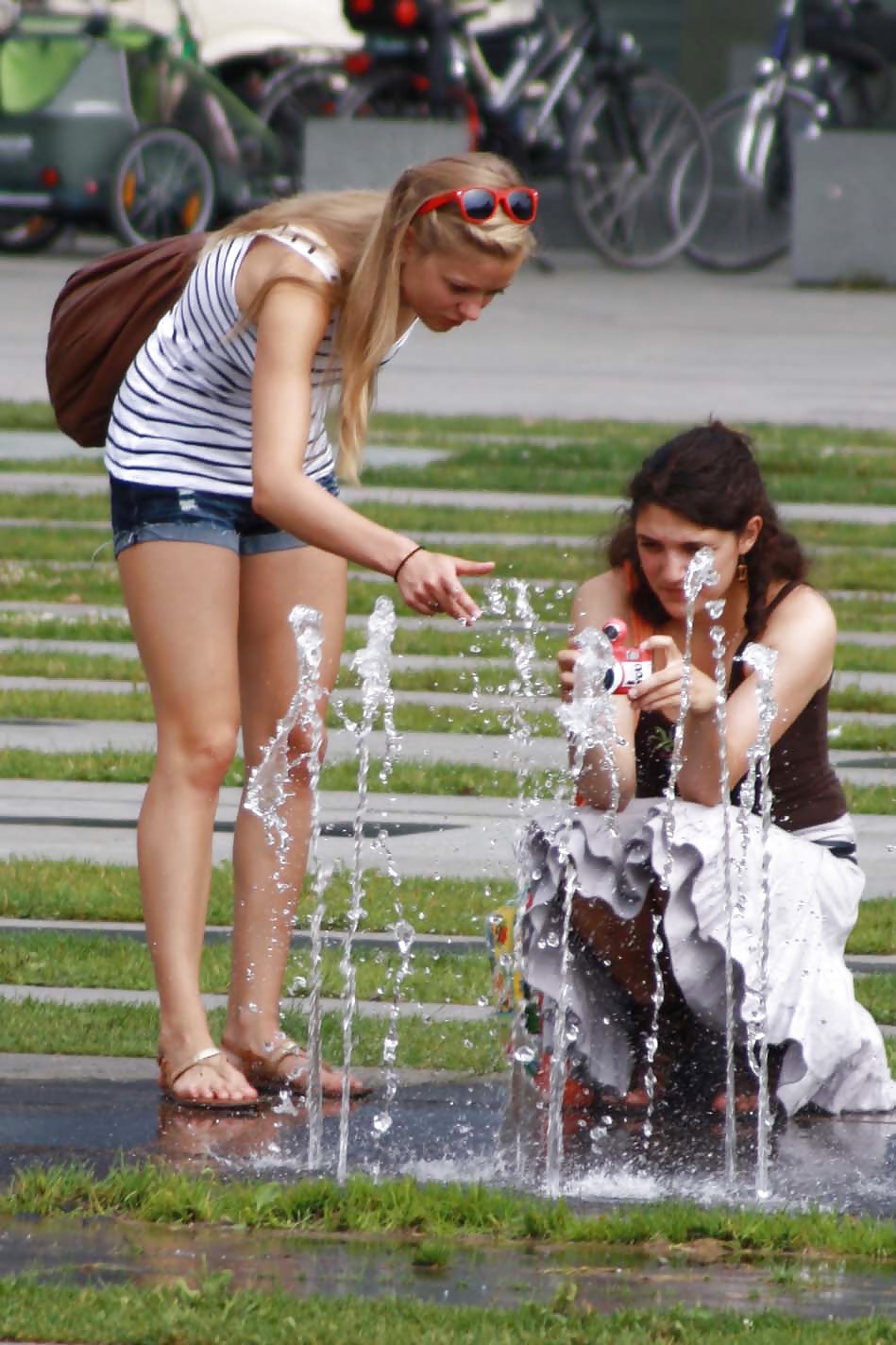 Two sexy and young girls takes photos on a fountain #11126415