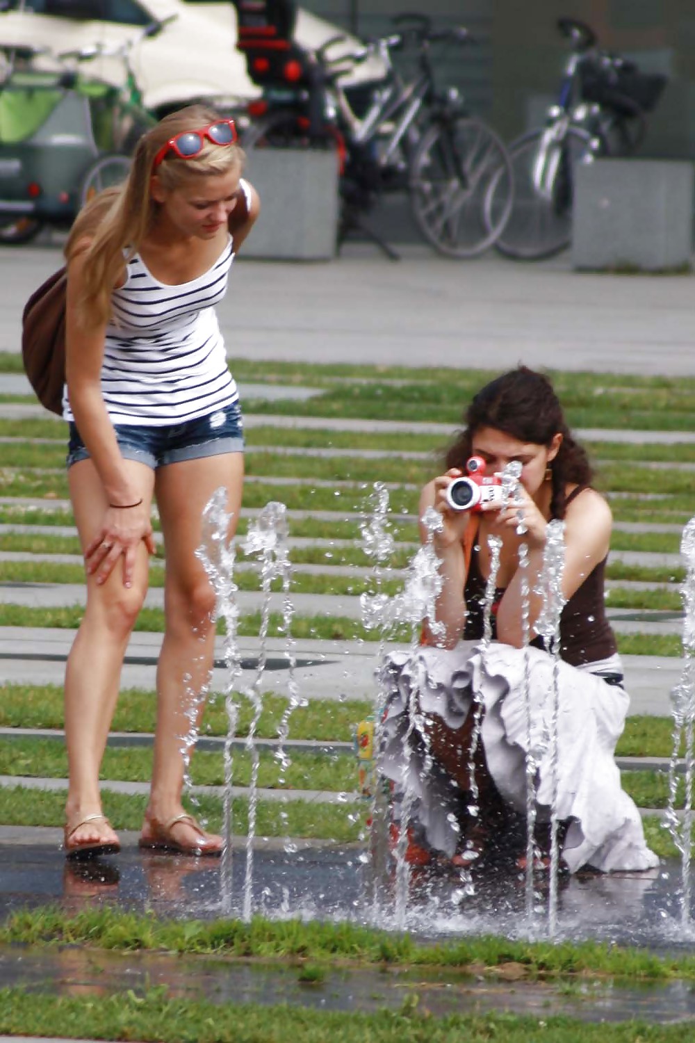 Two sexy and young girls takes photos on a fountain #11126437