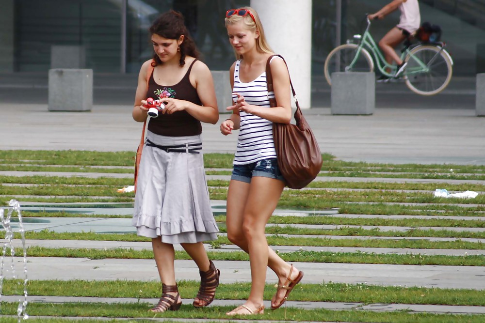 Two sexy and young girls takes photos on a fountain #11126463