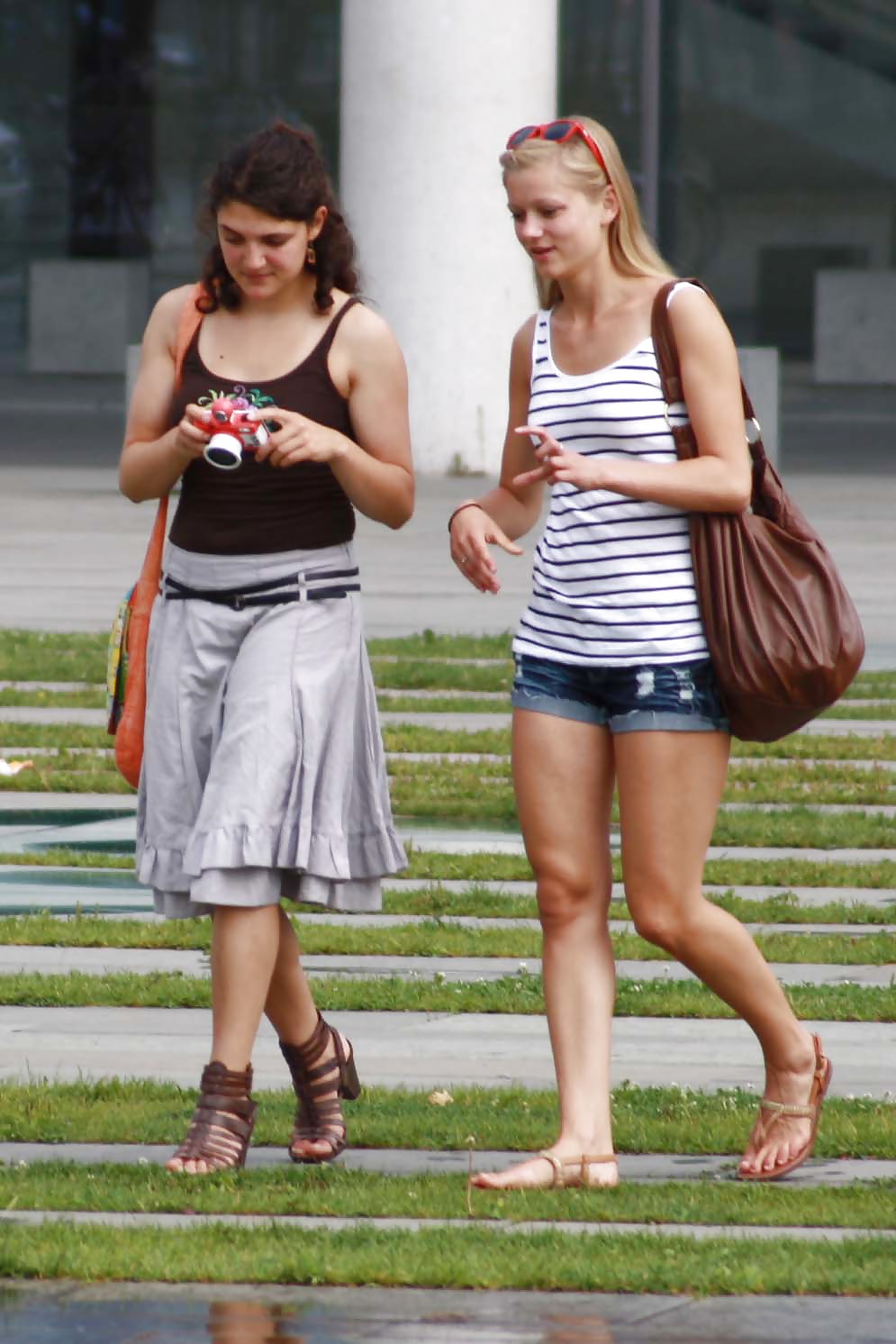 Two sexy and young girls takes photos on a fountain #11126474