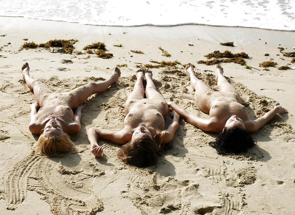 Sensuous 3 pretty kids at the seaside