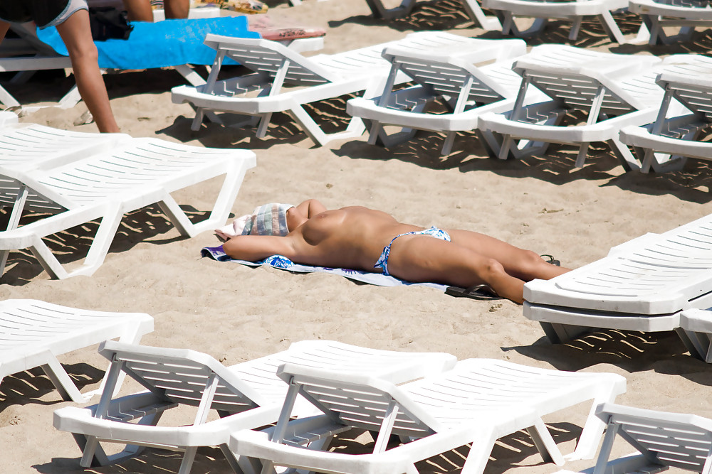 Thongs and toplessness on beach Ukraine))