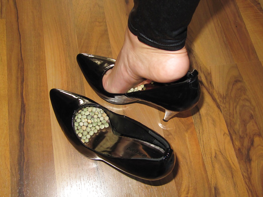 Foot torture with peas in high heels, leggings and corset #21593825