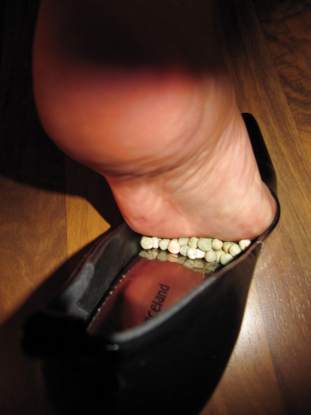 Foot torture with peas in high heels, leggings and corset #21593901