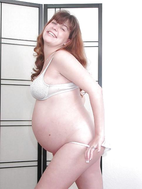 Pregnant brunette posing her plump body #16446033