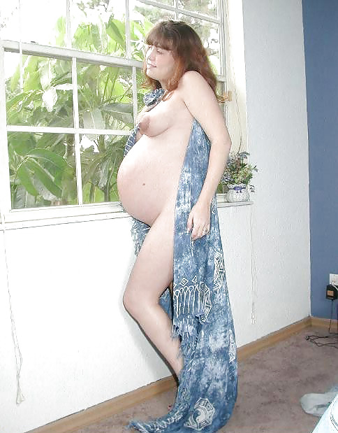 Pregnant brunette posing her plump body #16446368