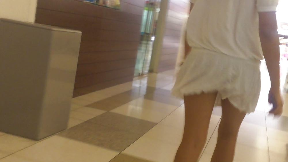 Cute girls ass & butt in short white mini skirt & red shoes #12647426