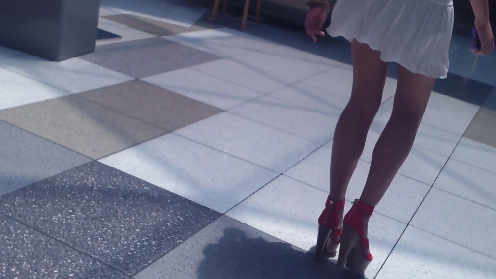 Cute girls ass & butt in short white mini skirt & red shoes #12647476