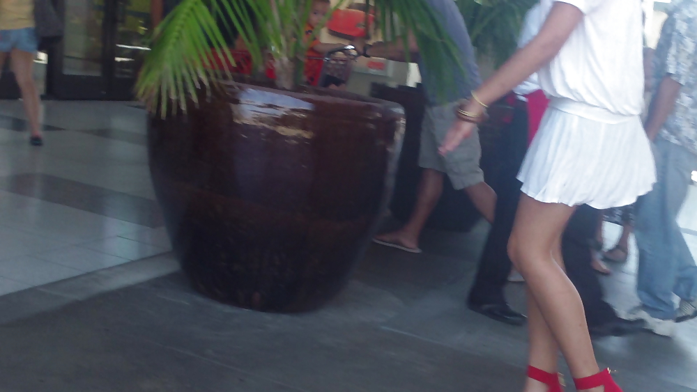 Cute girls ass & butt in short white mini skirt & red shoes #12647493