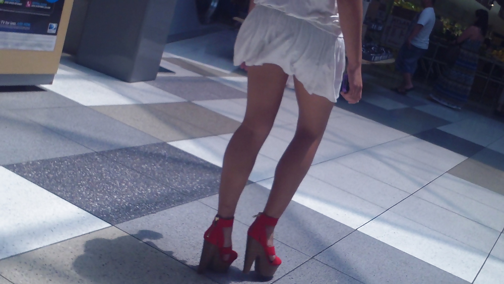 Cute girls ass & butt in short white mini skirt & red shoes #12647571
