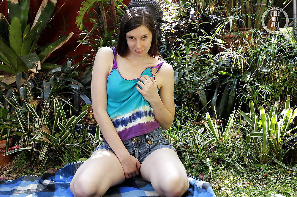 A pale Australian girl playing with a toy outdoors #21316640