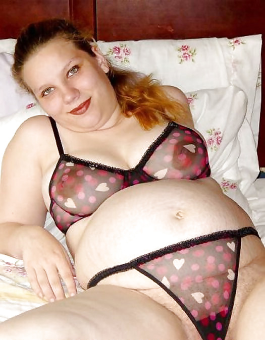 Pregnant brunette posing on her bed #14633383
