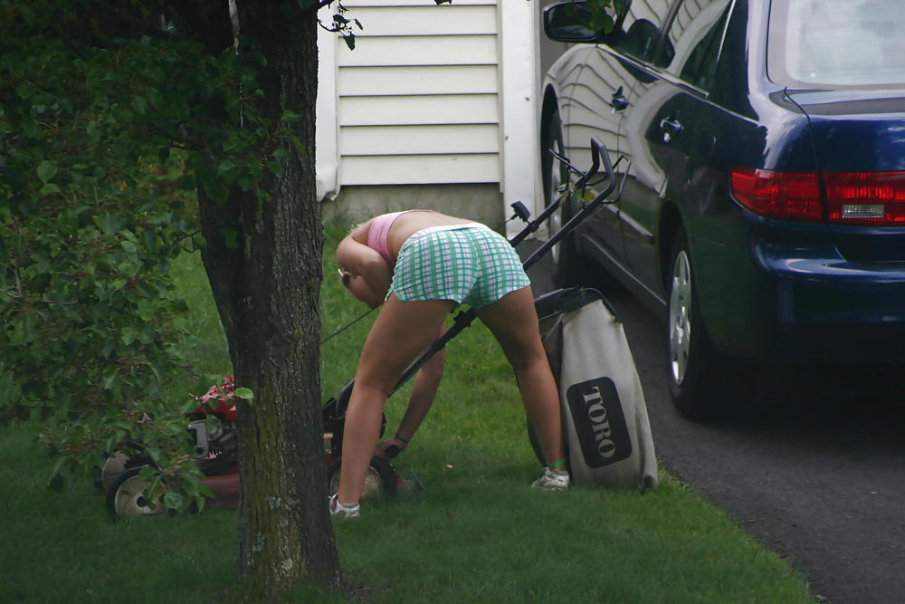 Neighbor mowing her lawn #5412501