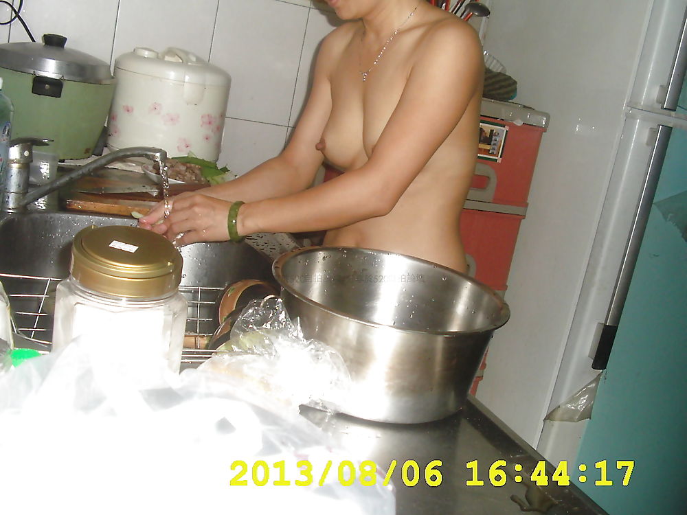 Chinese couple nude in kitchen