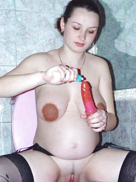 Lovely pregnant brunette playing with her dildo