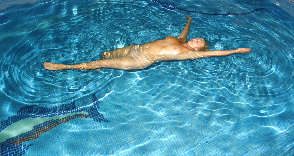 Floating in the pool #19015715