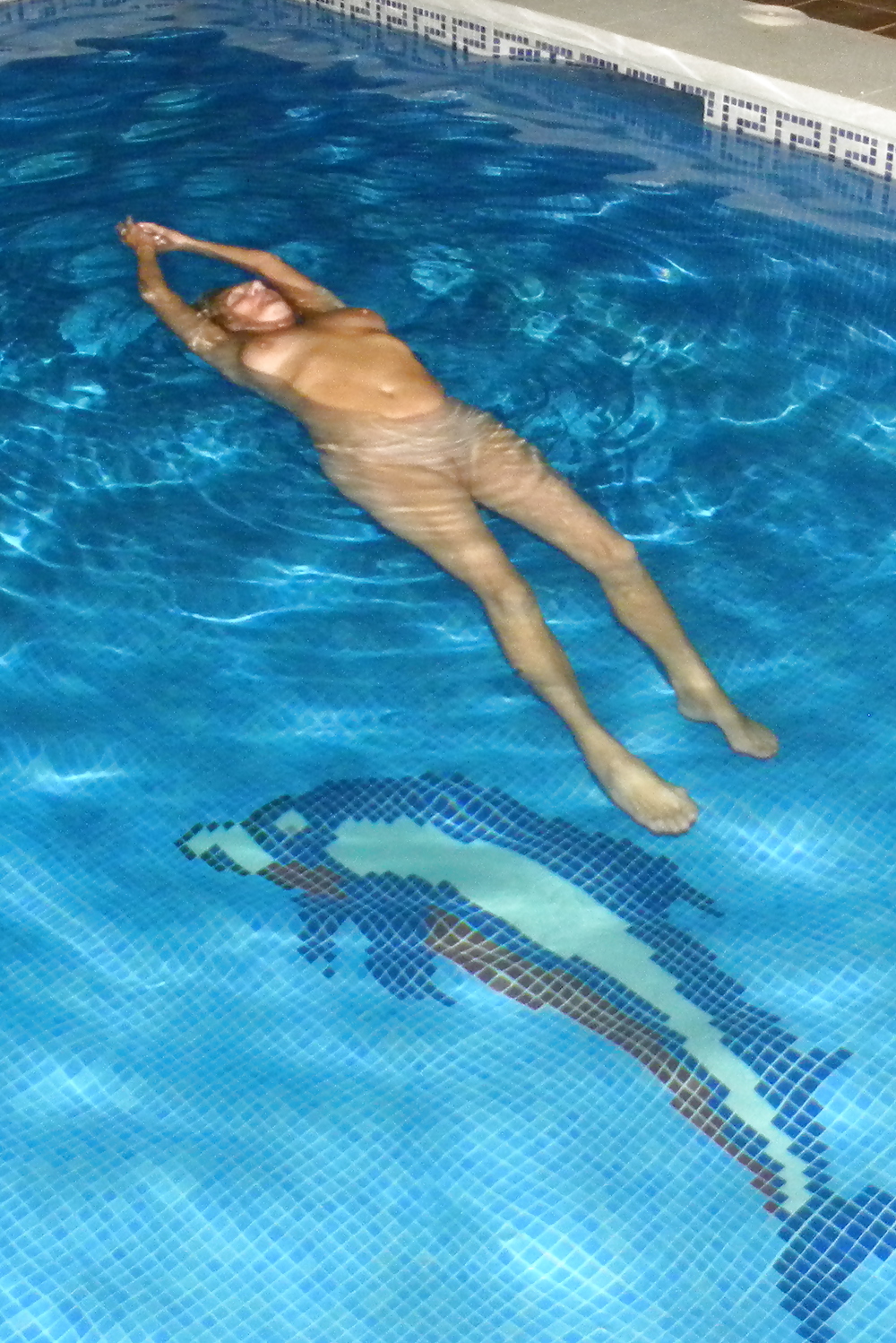 Floating in the pool #19015724