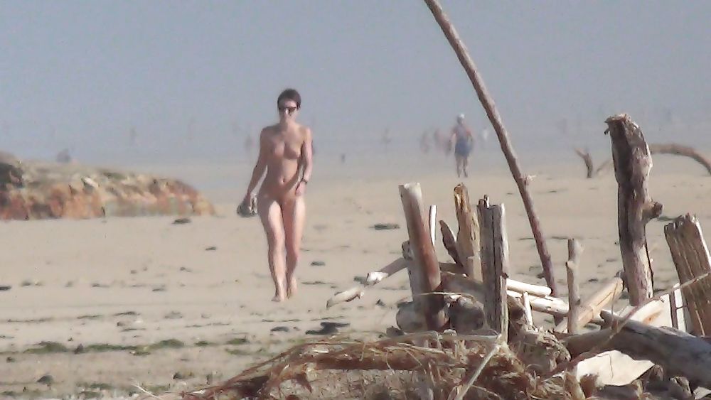 Nude lady walking on european seaside