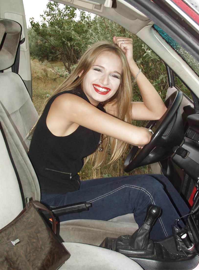 Blonde posing by her car #20688159