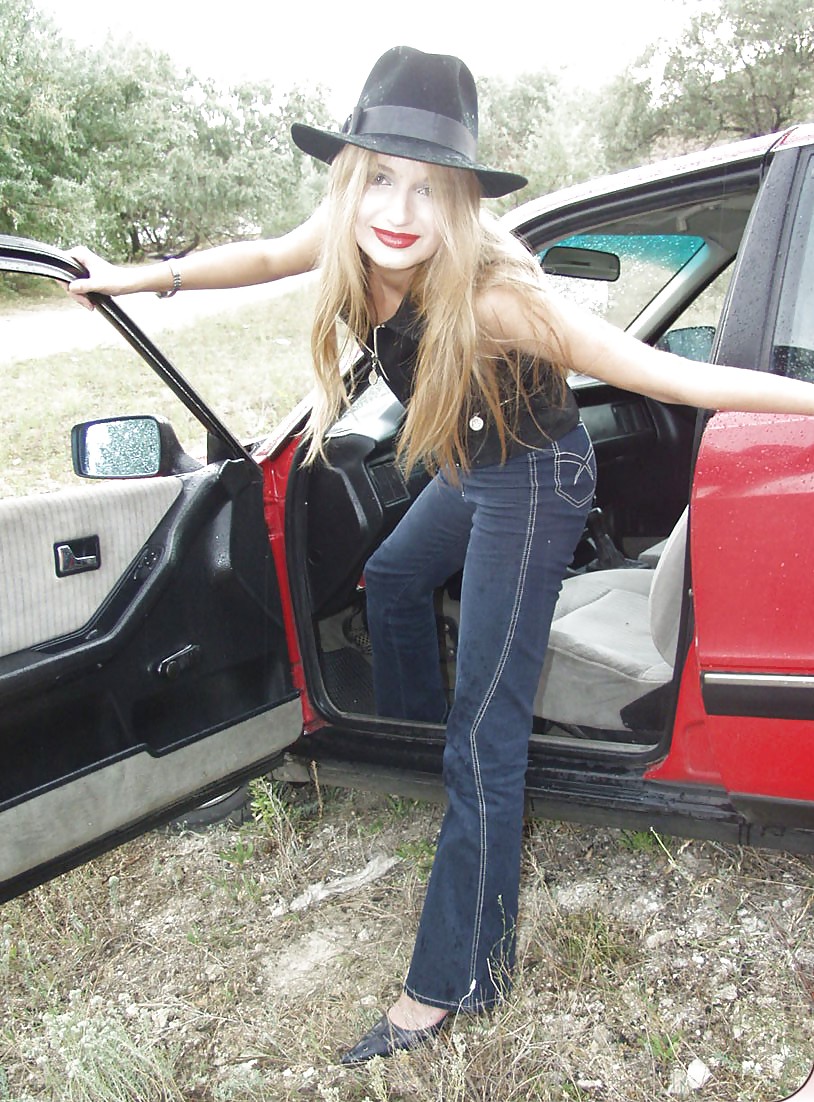 Blonde posing by her car #20688175