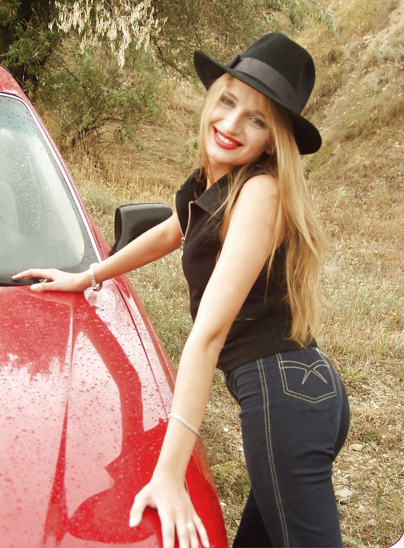 Blonde posing by her car #20688232