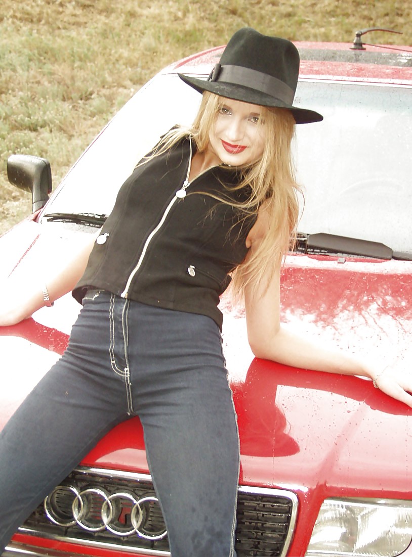 Blonde posing by her car #20688249