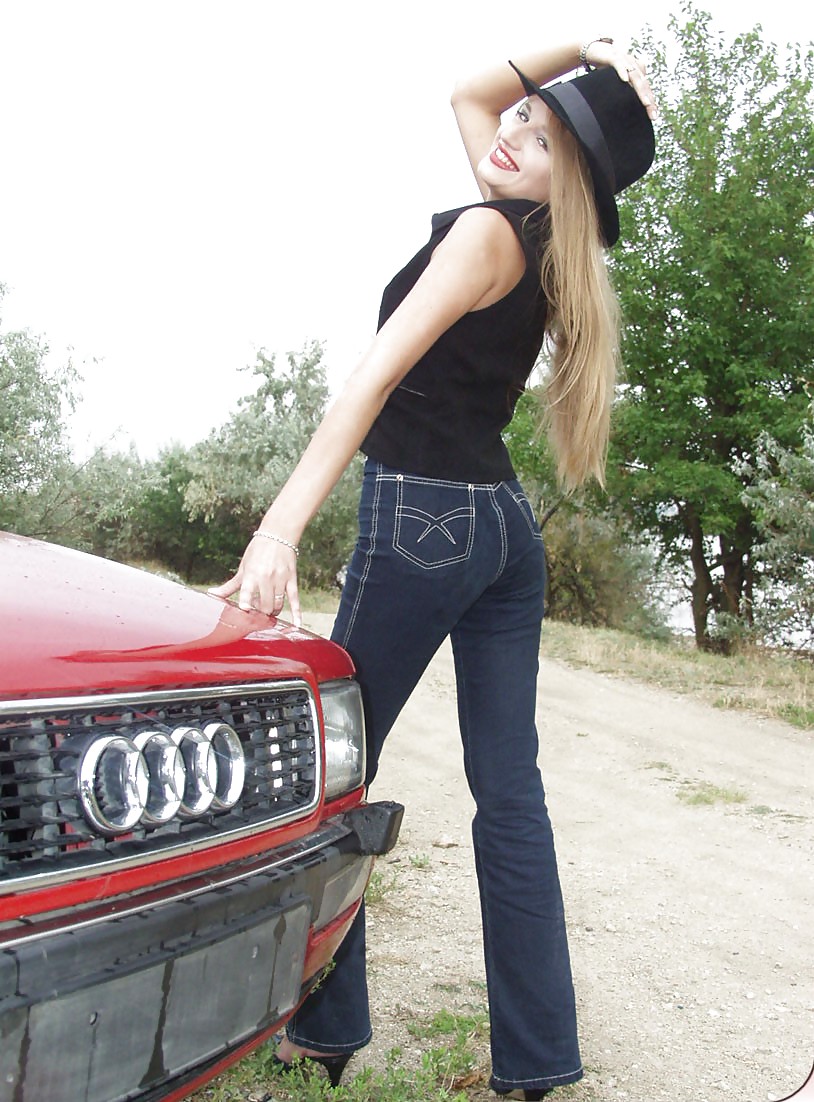 Blonde posing by her car #20688256