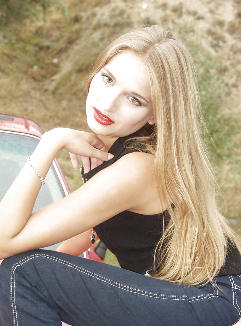 Blonde posing by her car #20688273