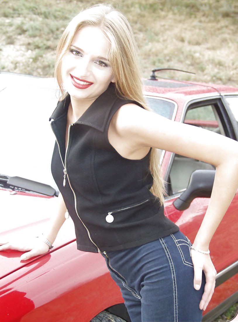 Blonde posing by her car #20688302