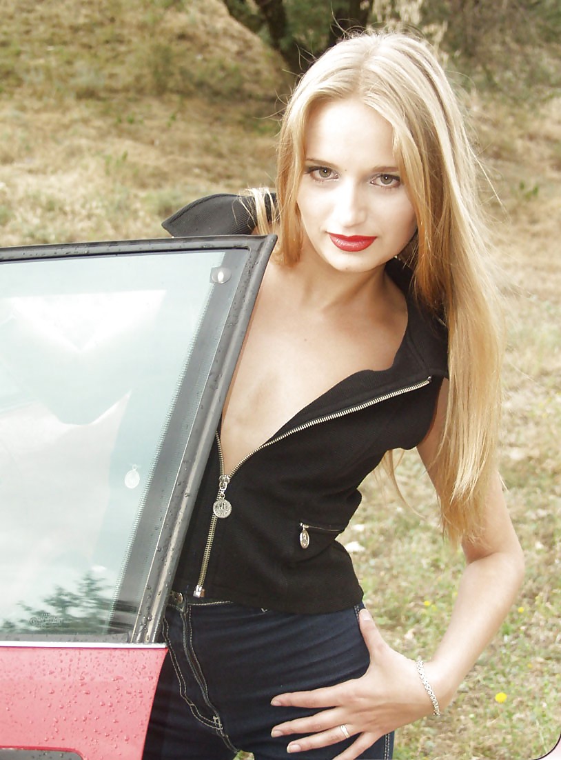 Blonde posing by her car #20688333