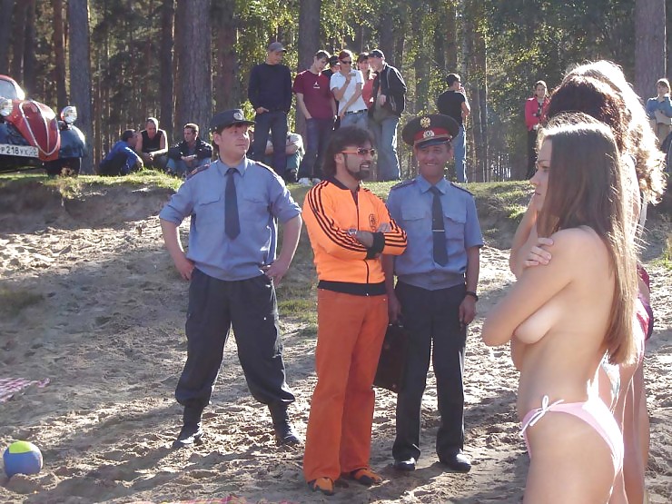 Topless girls in a forrest getting arrested (Russia?)