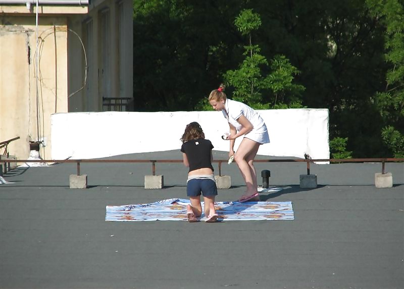 Three vouyered girls undressing and sunbathing in the roof. #37224175