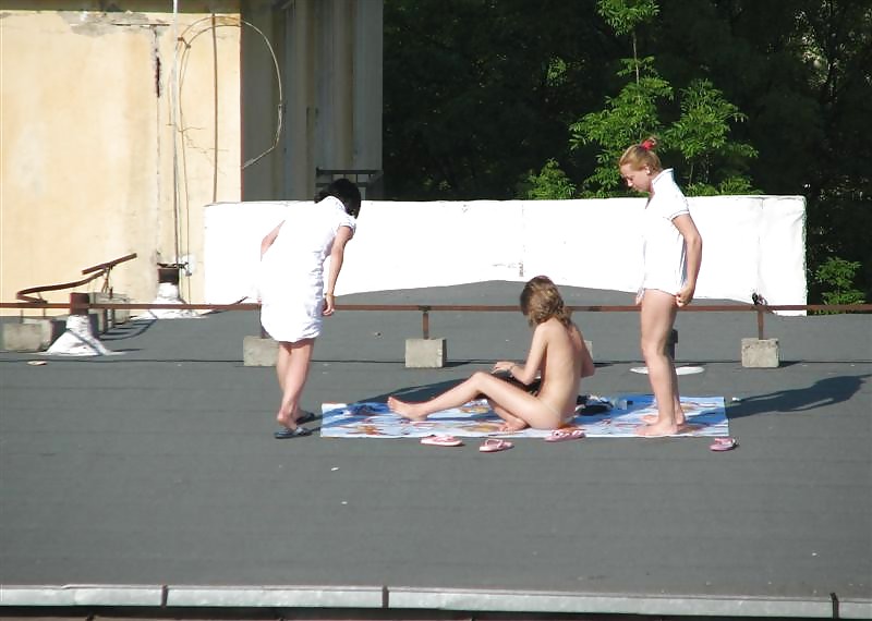 Three vouyered girls undressing and sunbathing in the roof. #37224186