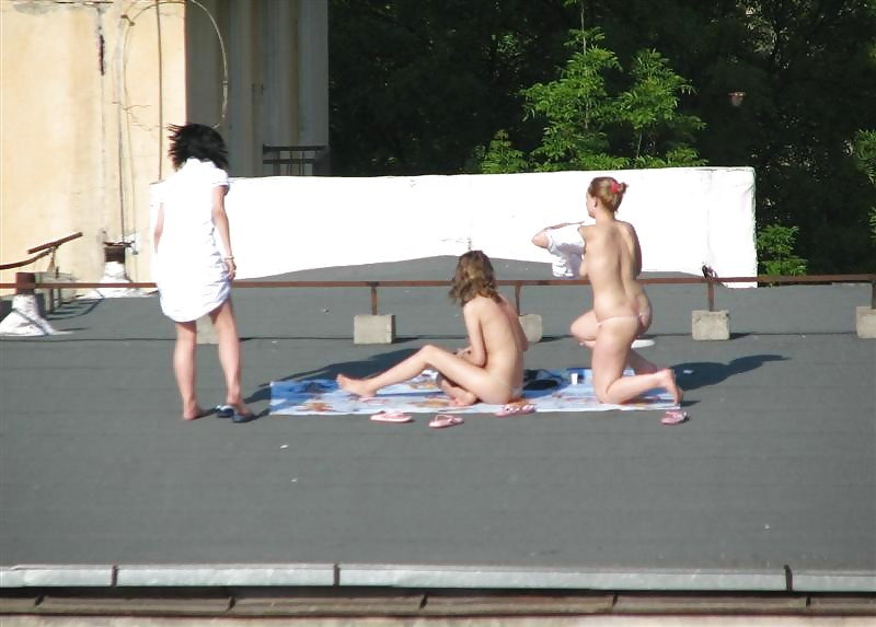 Three vouyered girls undressing and sunbathing in the roof. #37224188