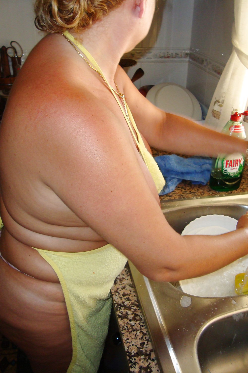 A beautiful mature woman in the kitchen #37053676