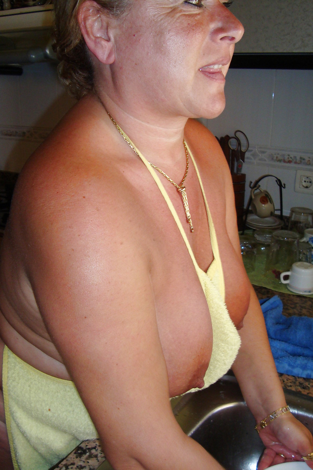 A beautiful mature woman in the kitchen #37053682