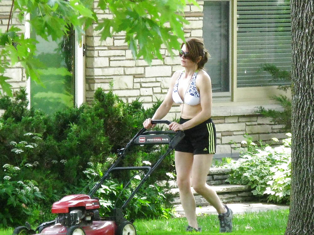Neighbor cutting her lawn #22926873
