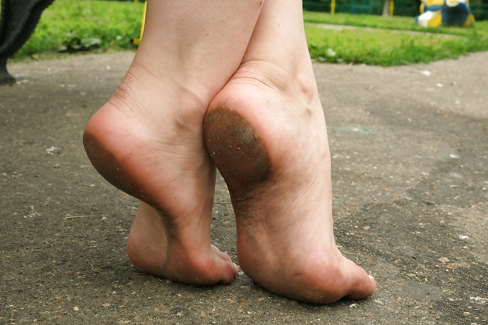 Girls  bare dirty feet  outdoor #25488661