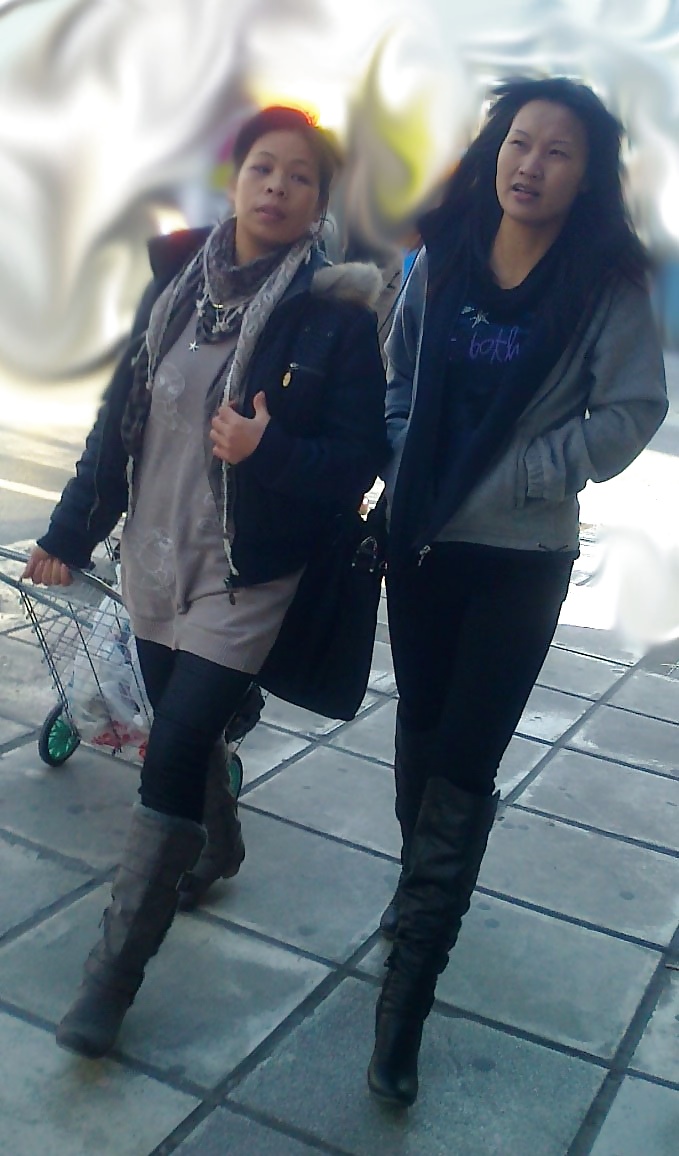 S. E. ASIANS  IN  GREEK  STREETS  WEARING  BOOTS #35281649