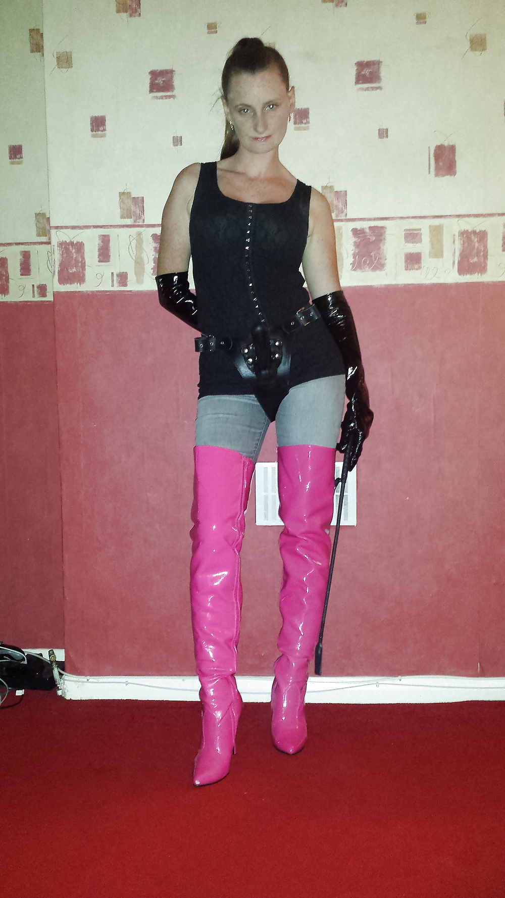 Strapon wearing mistress in pink thigh high boots