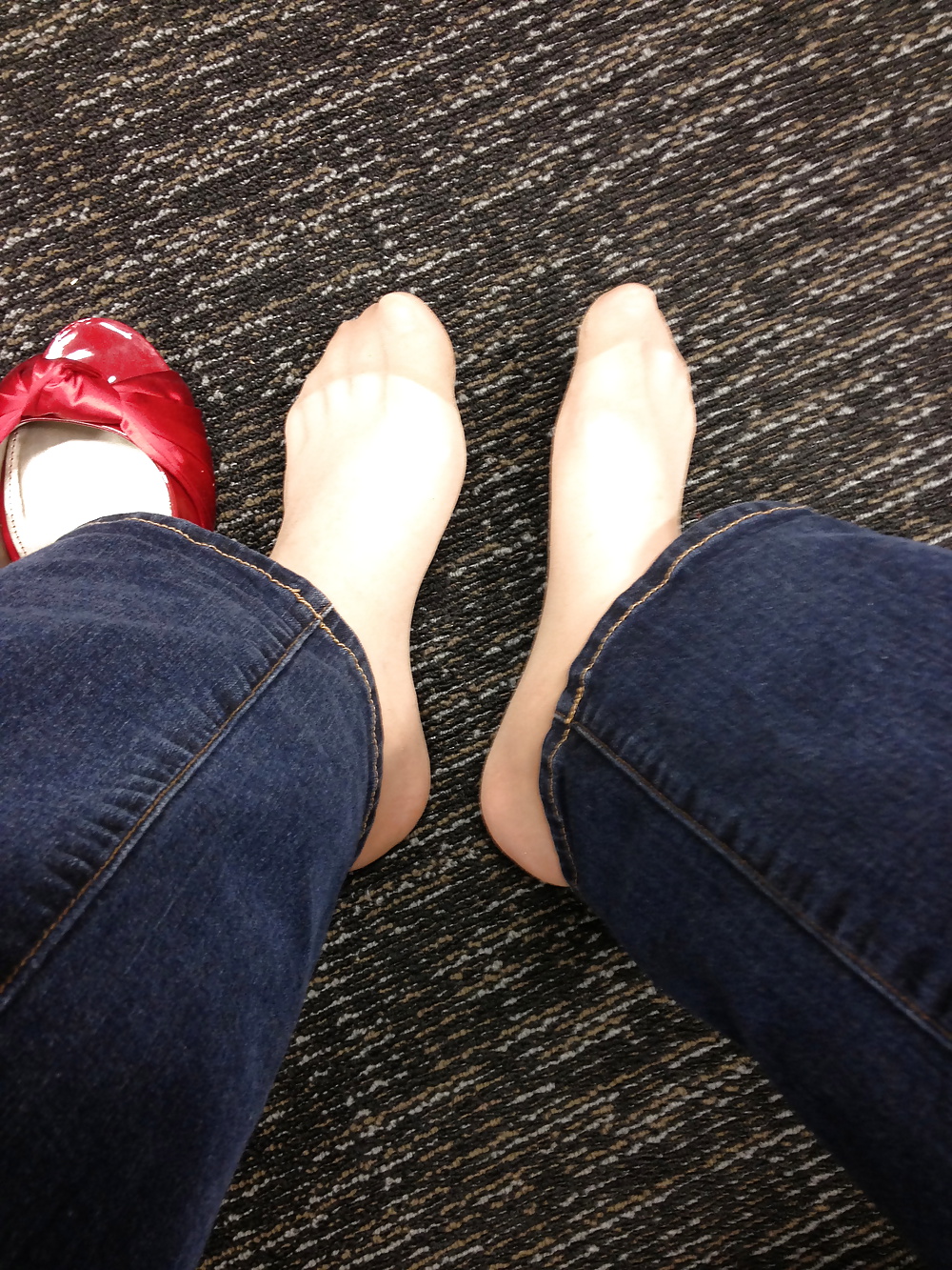 Stocking feet trying on red heels in shoe store #25674108
