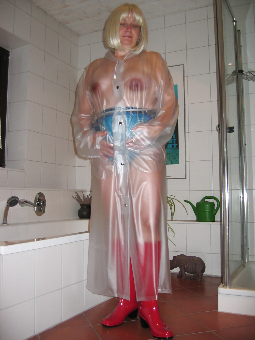 My wife wearing a transparent raincoat with rubber boots #36594917