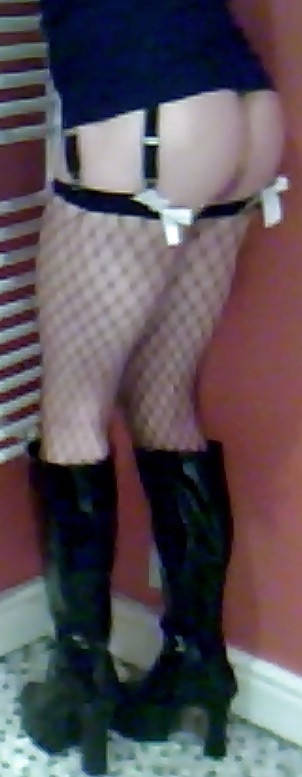 Fishnets, pvc boots and black short skirt #24401279