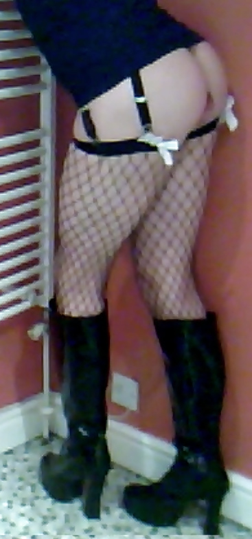 Fishnets, pvc boots and black short skirt #24401317